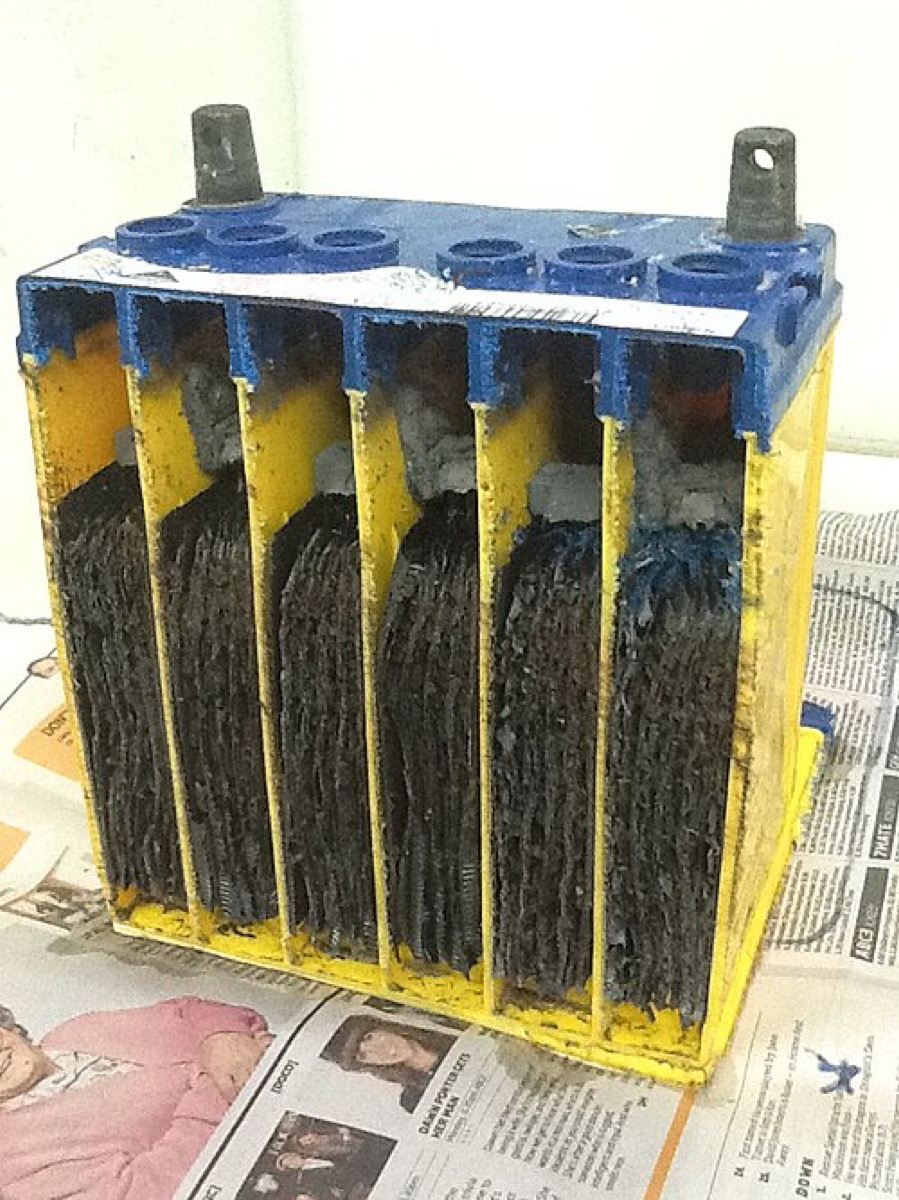 A cutaway lead-acid car battery showing its plates.