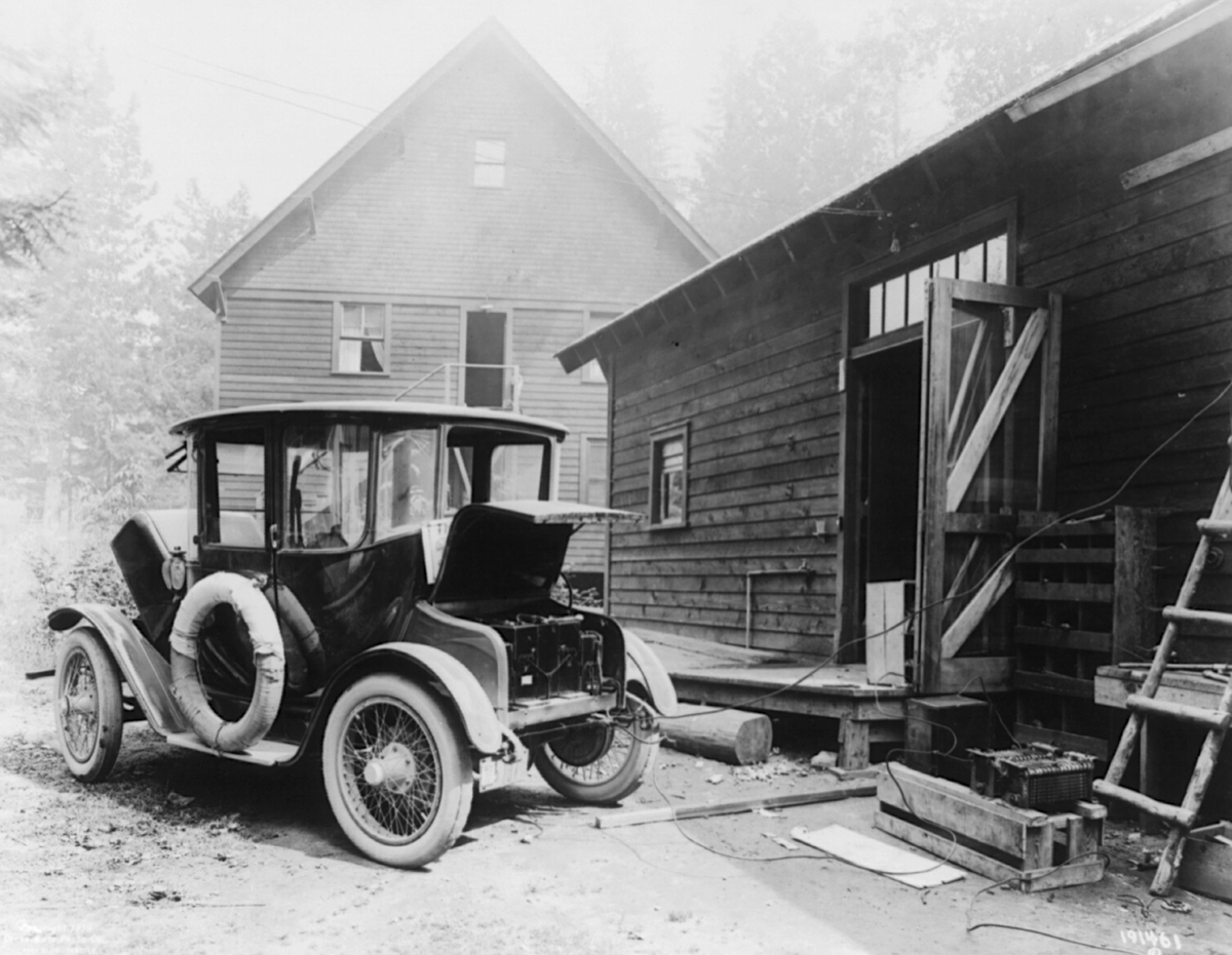 A Detroit Electric car being charged from a shed in the early 1900s.