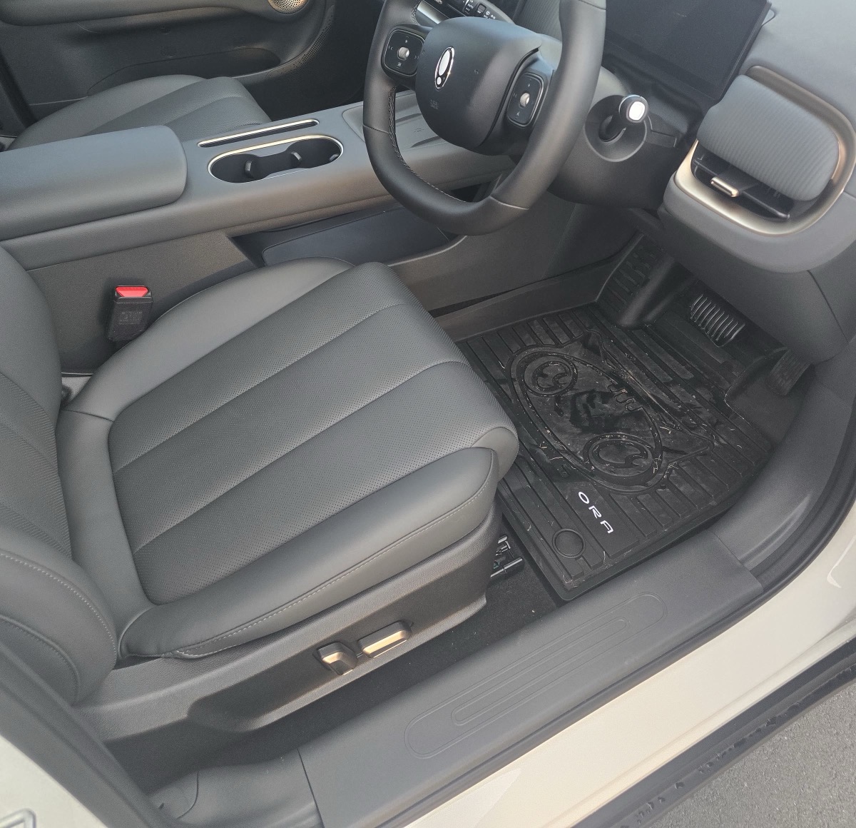 The Ora 5 Ultra's dark front seats, steering wheel and screens.